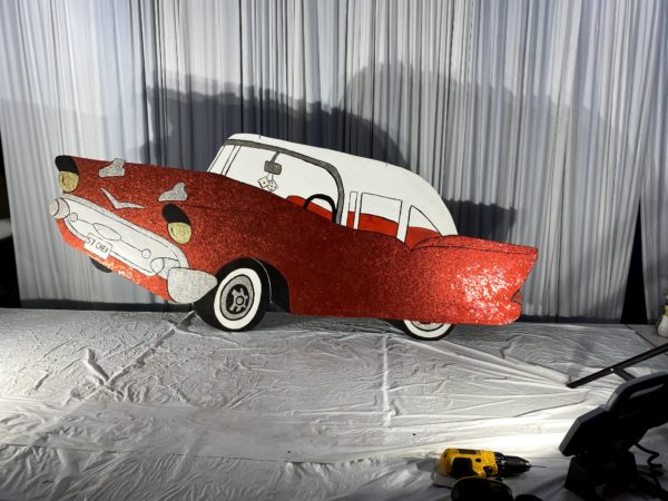 Wood Cutout Prop of a red amd wjote 1957 Chevy Car