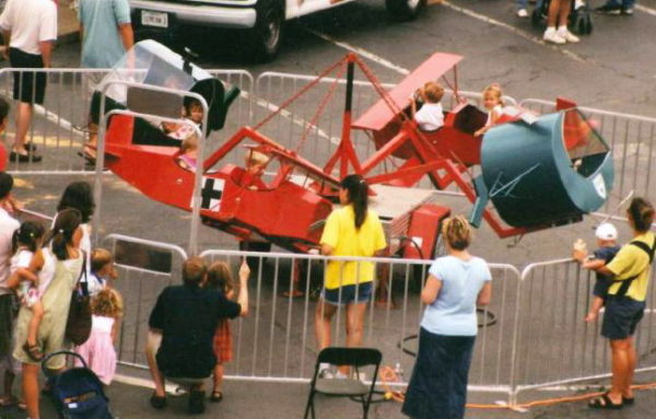 Photo of a kiddie amusement ride with bi plane and helicopter aircraft