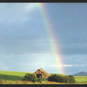 Photo of a banner that has an old rustic barn with a rainbow in the sky
