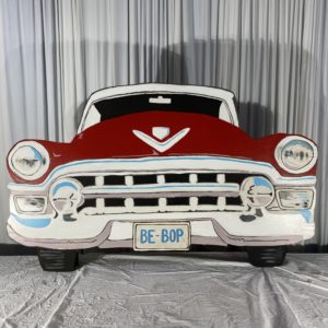 Prop of the front end of a 1950;s red cadillac