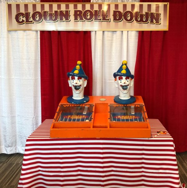 Carnival Game with two clown heads that balls are placed in the mouth