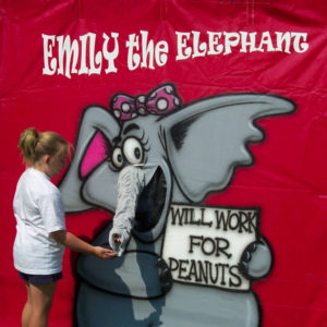 Carnival Game for Children with a big comical elephant that children feed a plastic peanut to win a prize
