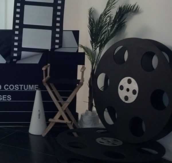 Assorted Props for Hollywoood Theme party rentals including giant clapboard film strips reels and directors chair