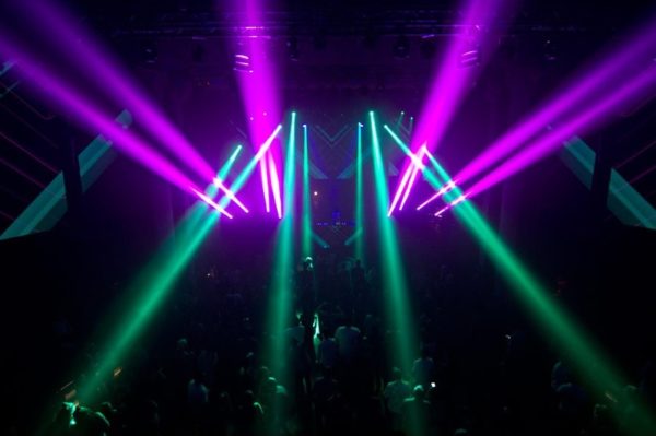 Photo of light beams from a party using a hazer machine to create a fog look