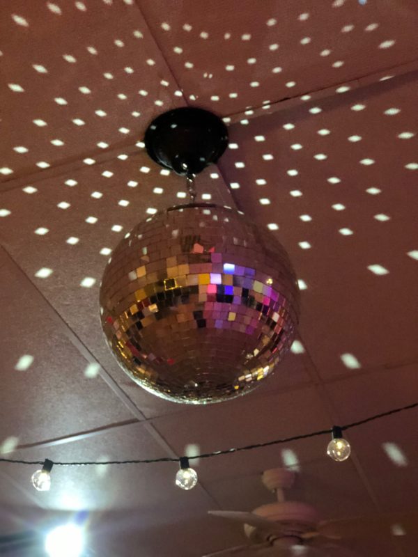 Photo showing light reflecting off of a mirror disco ball