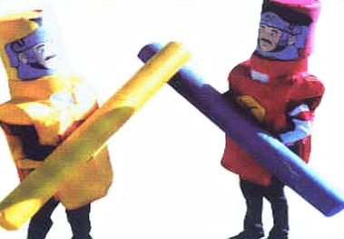 Photo of two contestants trying to knock the costume head off of their opponent with padded jousting sticks