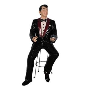 Photo of a Dean Martin type Statue sitting on a bar stool drinking a martini