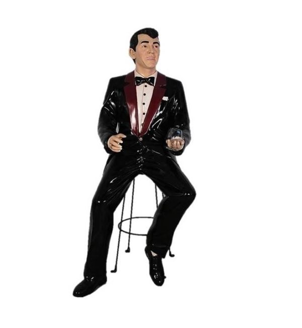 Photo of a Dean Martin type Statue sitting on a bar stool drinking a martini