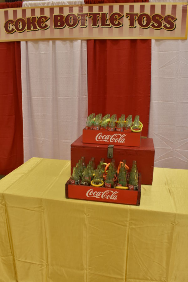 Carnival Game tossing plastic rings over necks of coke bottles