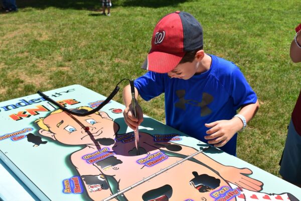 Child Playing Giant Operation Surgery Style Game