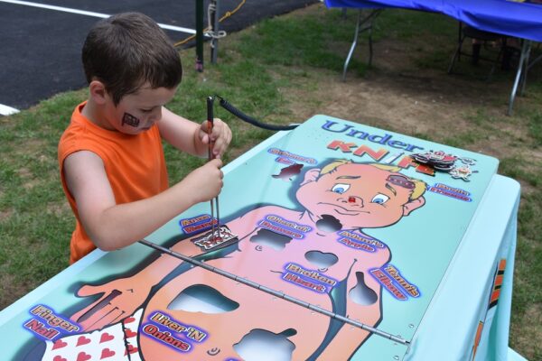 Child Playing Giant Operation Surgery Style Game