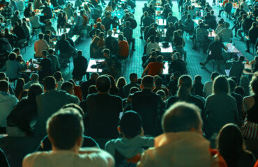 People watching football in a public place at night