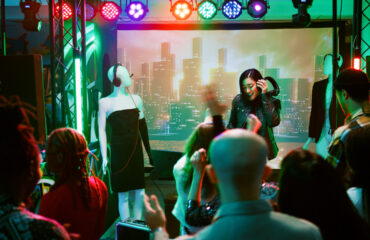 Female DJ having fun on nightclub stage