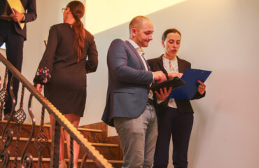 Business team walking on stairs meeting colleagues working